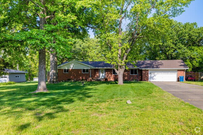 Older ranch-style homes sit among mature trees in the Lake Springfield neighborhood.