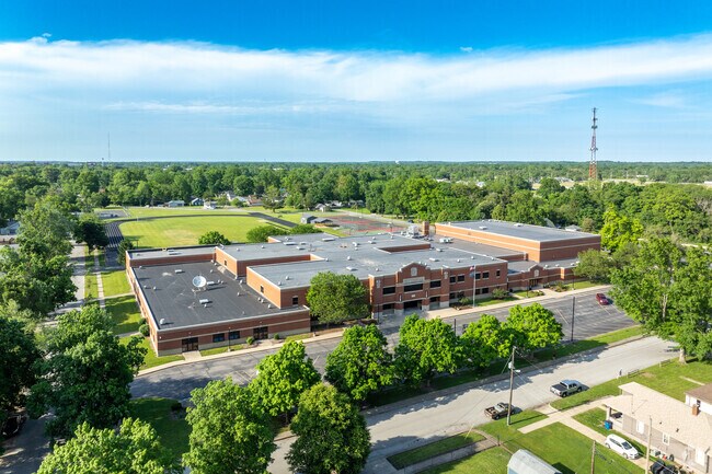 Sarah Scott Public Middle School has a parking lot and green open space for sports.