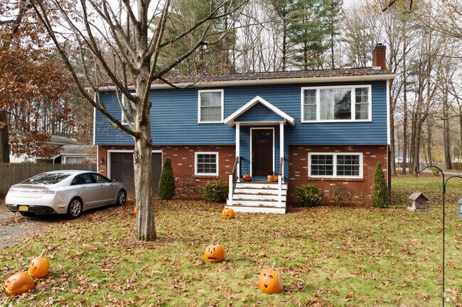 A classic colonial in Wilton with a seasonal pumpkin display out front.