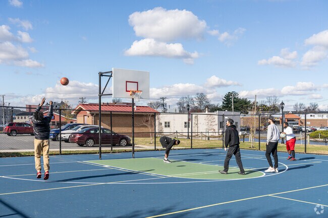 A group of friends gets down to some competitive basketball at Milford's Bicentennial Park.