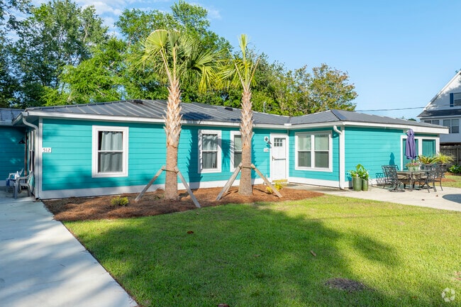 Surfside Beach features charming coastal cottages like this vibrant bungalow, perfect for a relaxed seaside lifestyle.