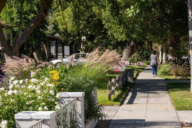 Yards adorned with vibrant flowers and bushes line the sidewalks in the Rancho Adjacent.