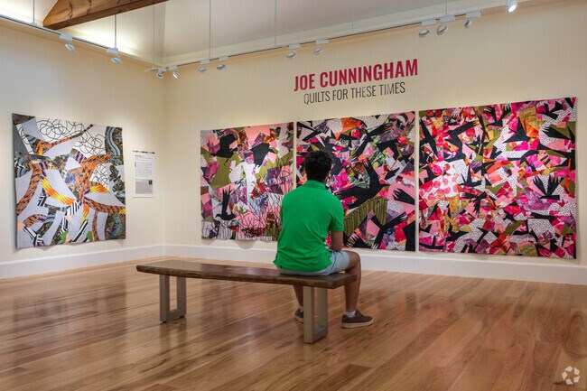 A Cotuit resident sits and admires the exhibits at the Cahoon Museum of American Art.