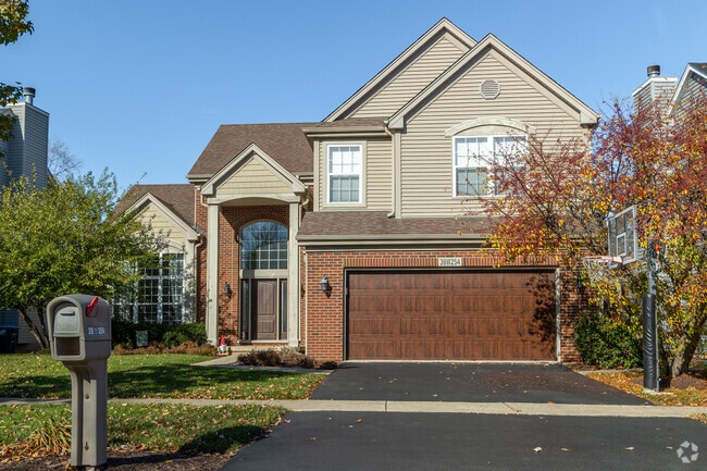 Two toned home with a newly installed garage door stands out in the neighborhood of Aurora.
