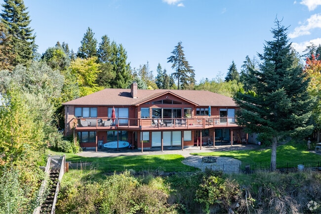 Modern and contemporary cabins sit between the thick trees in the Port Gamble Tribal Community.