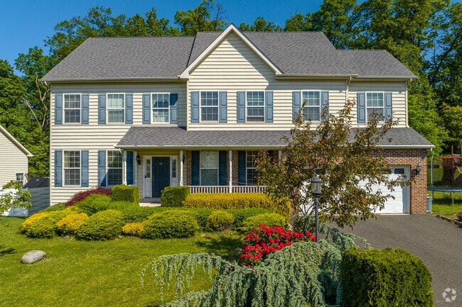 Modest-sized three-story colonial homes line Pottsgrove developments.