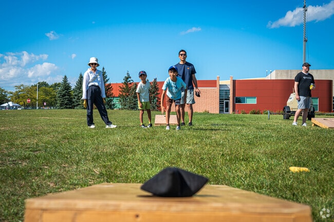 Families practice their bags skills before the annual Bags Tournament in Buffalo Grove.