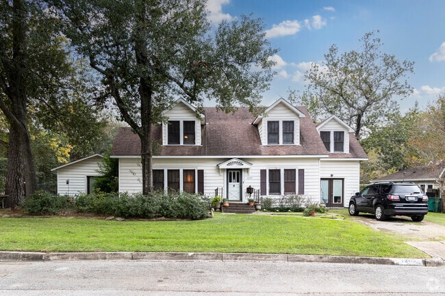 A two-story, Cape Cod home in Conroe with a large lot.