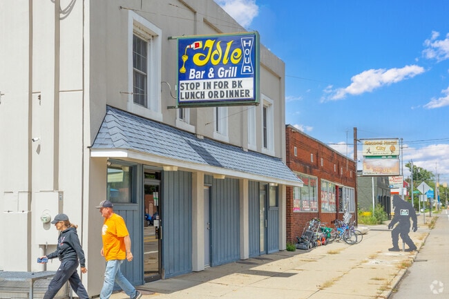 Two patrons exit the front door of Idle Hour Bar & Grill.