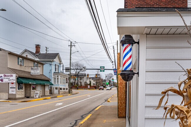 An old fashion barber shop pole outside a shop in Allison Park.