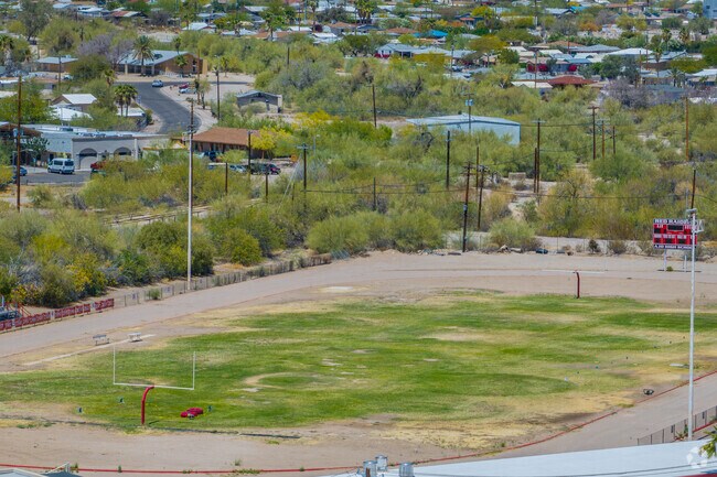 The campus features a shared athletic field used by students from both school for physical education and community sporting events.