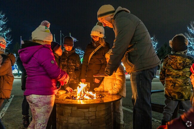 Families gather around the fires at Christmas in the Commons in New Lenox.