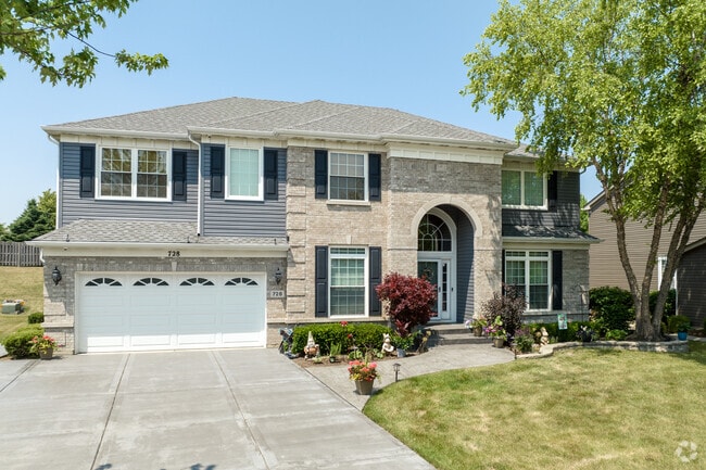 Modern build style home with a mix of horizontal siding and brick finishes located in Elk Grove.