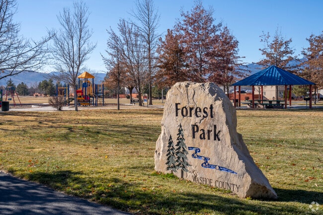 Forest Park has large grass fields with a gazebo, playground and basketball in the center.