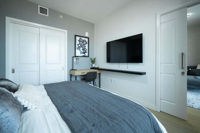 Bedroom has a TV and working desk