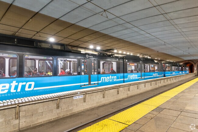 Use the red or blue lines at the Convention Center MetroLink station near Columbus Square.