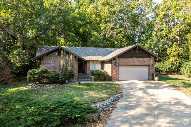 Ranch homes with long curving driveways have backyards shrouded in shade trees in West Campus.