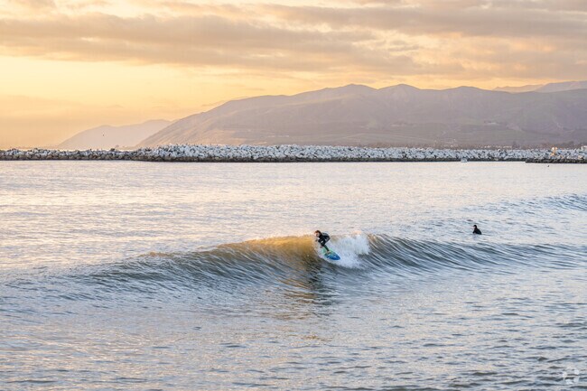 Locals spend their evening at one of Oxnard's many beaches surfing.