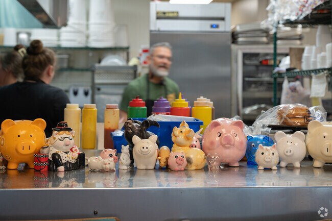Charlie's' BBQ shows off its many piggy banks on the counter in Odneville.
