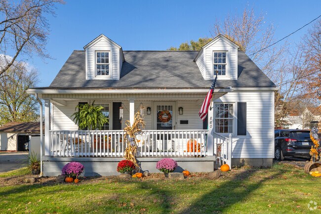 Cape Cod home with a tidy lawn and quaint front porch in Sharpsville.