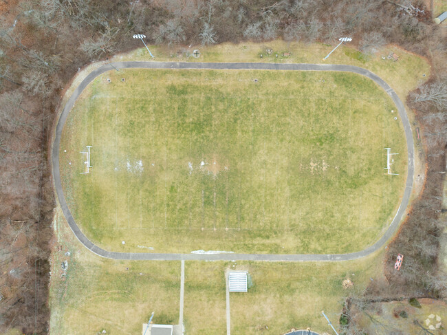 There is a football field near the school building.