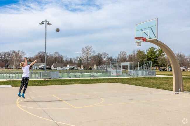 A full-sized basketball court also draws Merle Hay residents to Tower Park for some hoops.