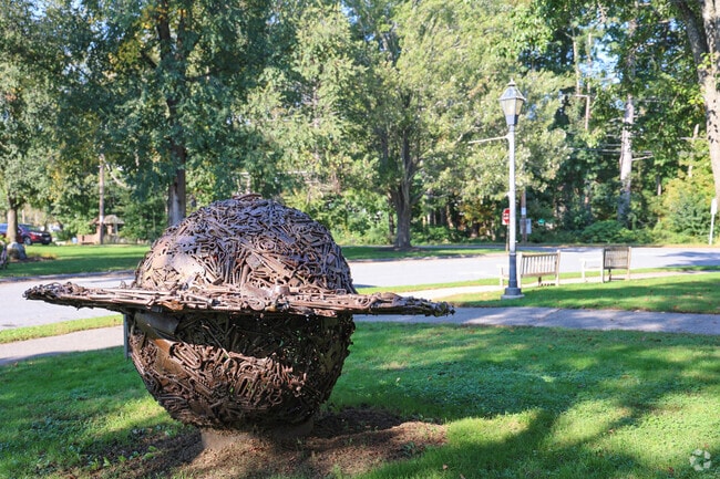 The sculpture Saturn by Jame Kitchen is sitting outside the Topsfield Public Library.