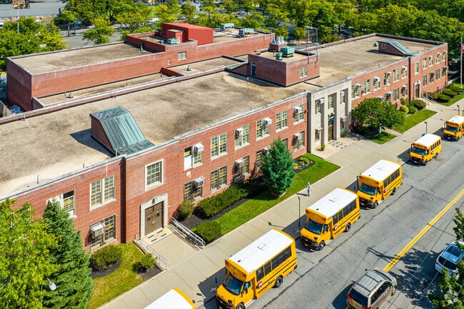 Bus lines up during school closing time in front of PS 811Q