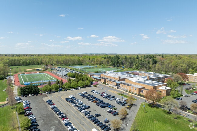 Notre Dame High School is surrounded by trees and greenery.