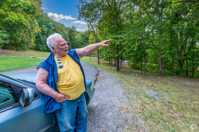 A gentleman in Jerome Park takes a few moments to give directions to someone from out of town.