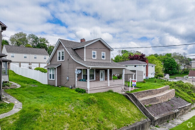 A bungalow style home situated up on a hill in Brackenridge.