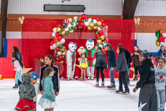 Families enjoy getting pictures with Santa at the Nile's IceLand Santa Skate