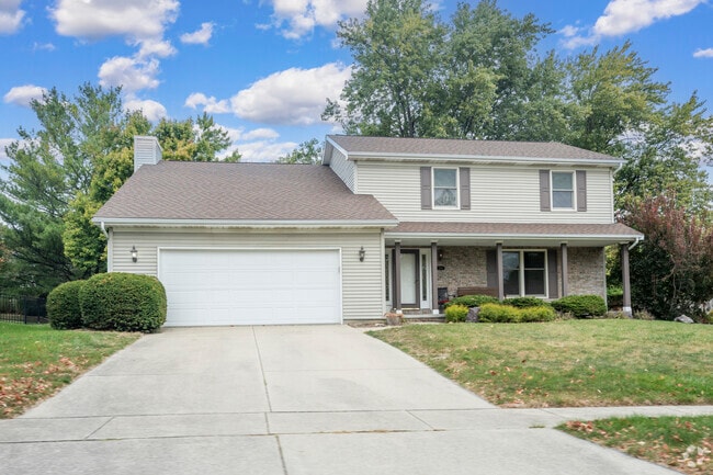 Colonial style and split-level homes in Oakridge feature expansive green space and foliage.