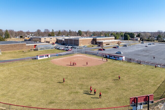 The high school students enjoy playing outside on a warm sunny day.