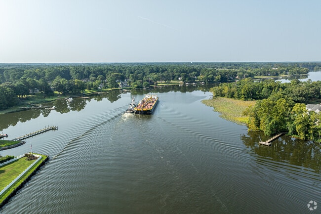 A tugboat pushes a barge lazily down the Wicomico River through North Camden.