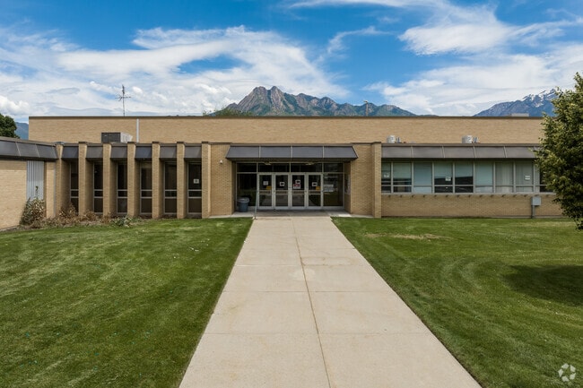 A wide sidewalk leads to the main entrance at Twin Peaks Elementary School.