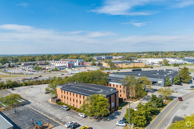 Overview of Focus North High School's campus surrounded by lush trees.