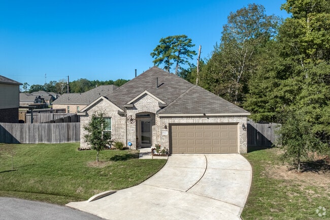 A one-story, Craftsman-style home with modern amenities and an attached garage in Splendora.