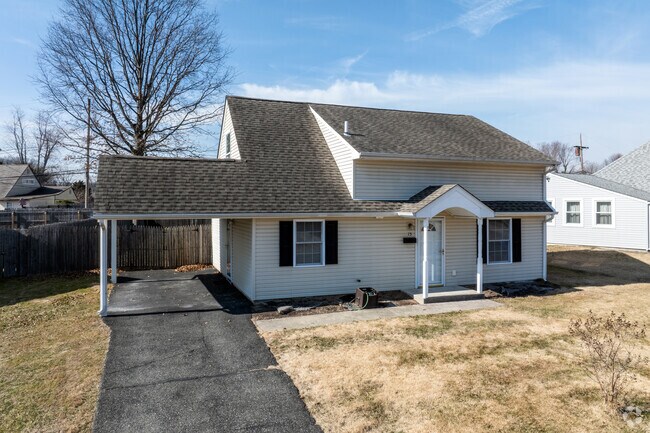 Many homes in Red Cedar Hill have carports, like this cape cod.