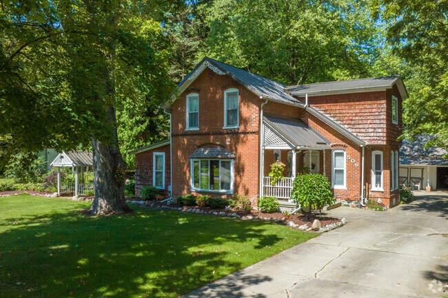 An historic Victorian is nestled into the heavily wooded neighborhood in Clio.