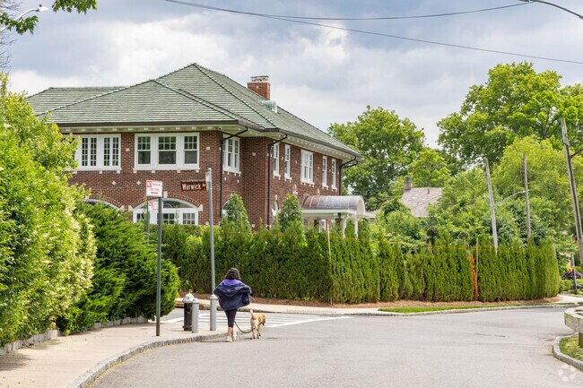 Several waterfront homes in Douglas Manor have large bushes in front for privacy.