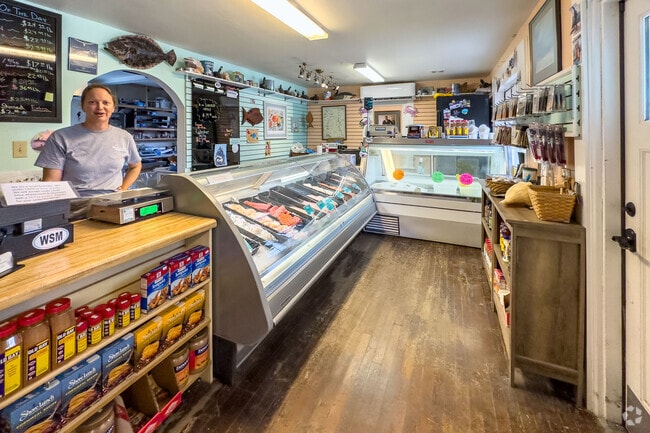Inside Welton’s Seafood Market, shoppers browse fresh catches in Linkhorn Park.