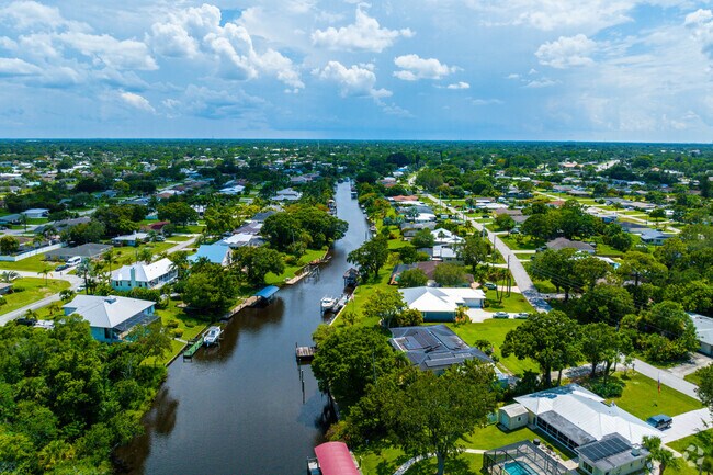 Aerial overview of single family homes on and around St Lucie River in River Park.
