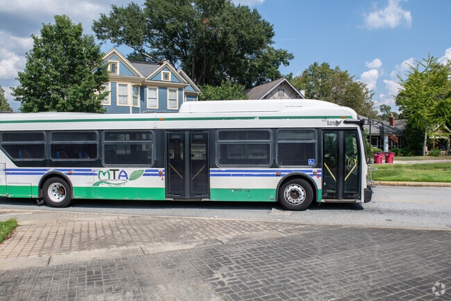 MTA busses roll through the Cherokee Heights Historic District neighborhood headed downtown.