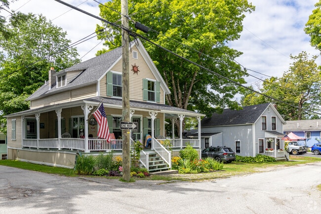 A row of homes including one with a large porch near the shores of Lake Sunapee in Newbury, NH.