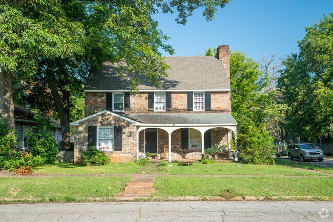 This colonial revival has the perfect shade tree for a hot summer day.