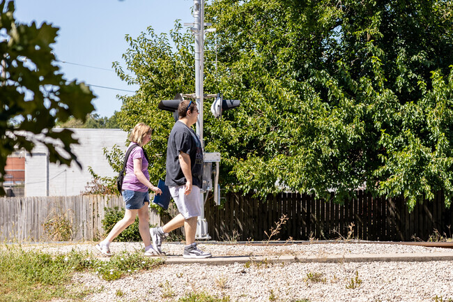 Sherman Ave residents enjoy an afternoon stroll along one of the neighborhood streets.