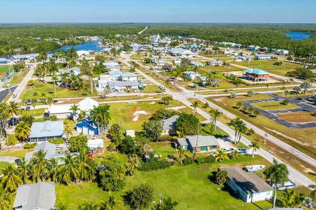 Residential streets in Everglades City are lined with palms and waterfront views.