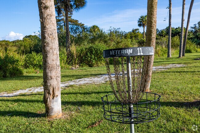 Disc golf basket at Donald B. Moore Preserve offers outdoor recreation under shaded trails.