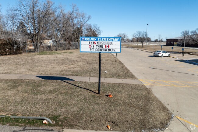 There is a sign for Colvin Elementary School near the main road.